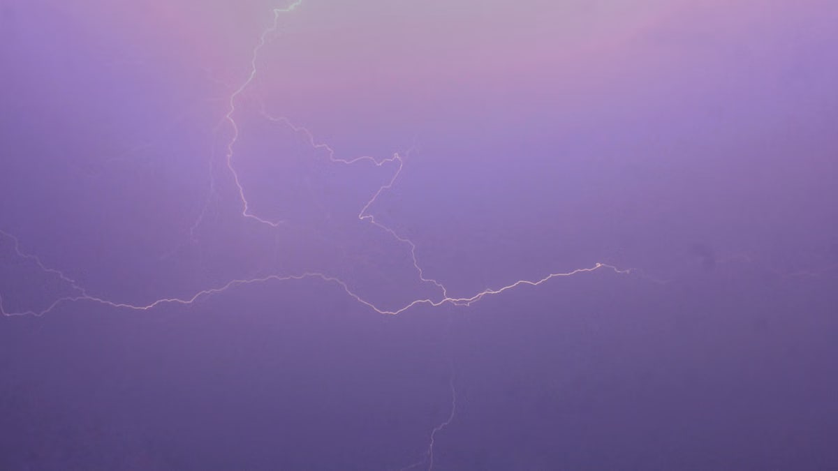 Mesmerizing lightning bolt captured against a vibrant purple sky, showcasing natural beauty and power.
